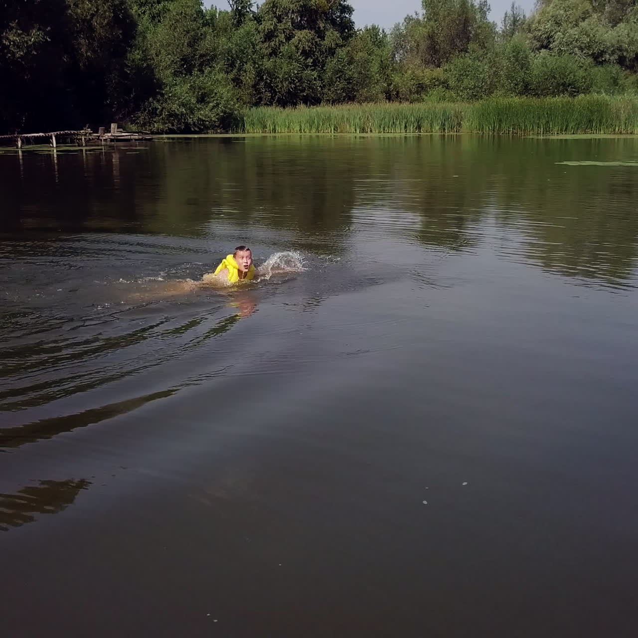 a boy is floating in the river. Aerial view.