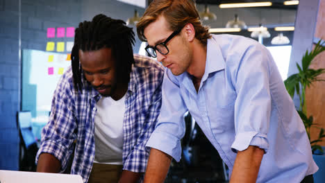 Colleagues-interacting-with-each-other-over-laptop