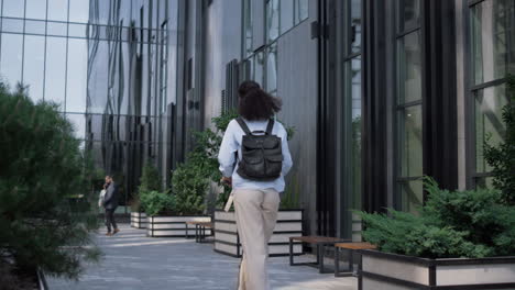 office manager riding electric scooter rear view. corporate lifestyle concept