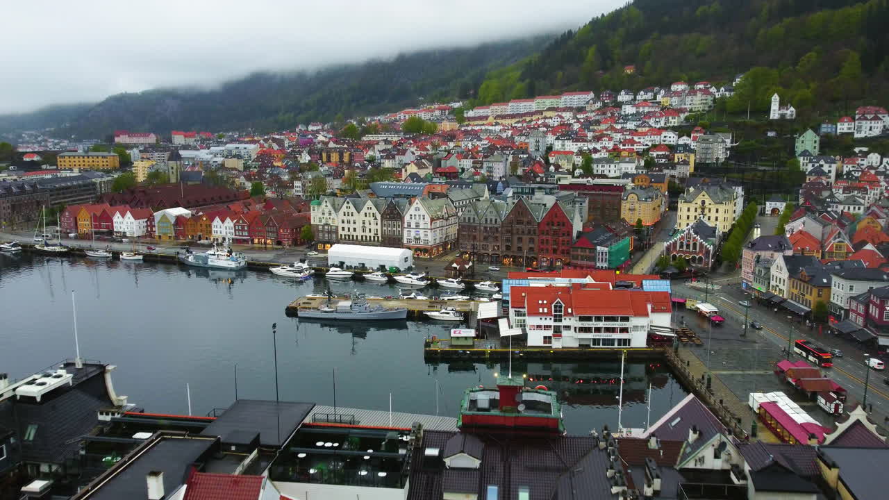 Drone shot in front of the colorful Bryggen wharf, gloomy, summer day in Bergen