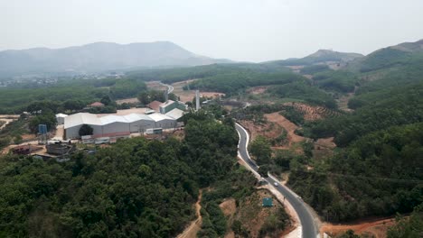 aerial view of a factory in a rural mountainous area