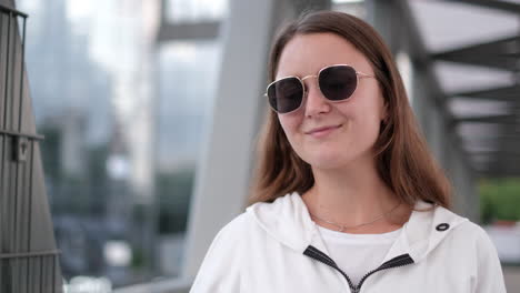 woman in sunglasses and white jacket