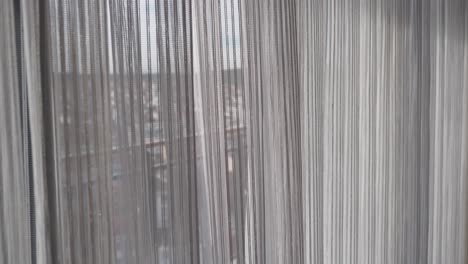 sheer white curtains with city view