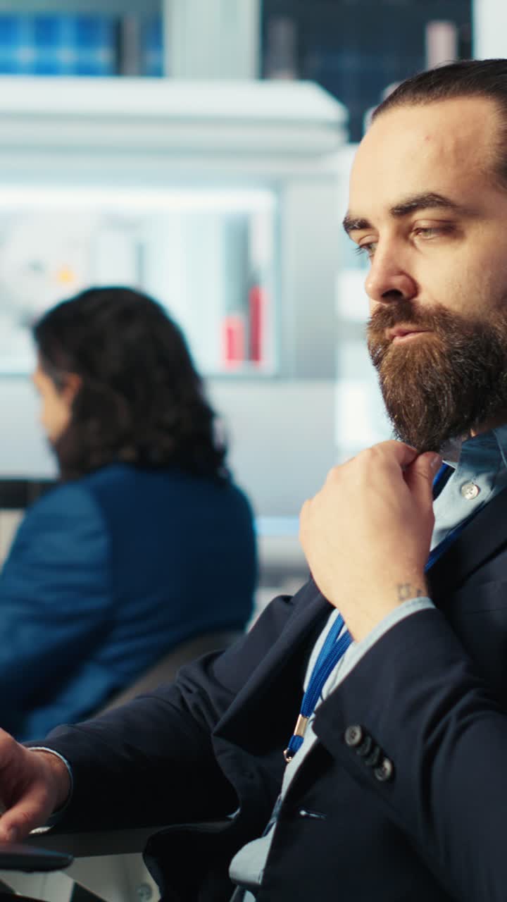 Vertical Video Specialist Using Laptop Inspects Machinery Placing Solar Cells On Conveyor Belts