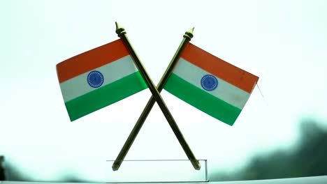 indian flag on car dash board in rain wipwer in happning long shot