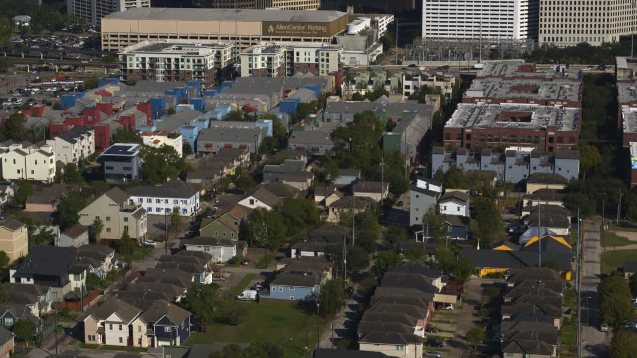 Pan up drone shot from homes in Houston Forth Ward that reveals downtown Houston