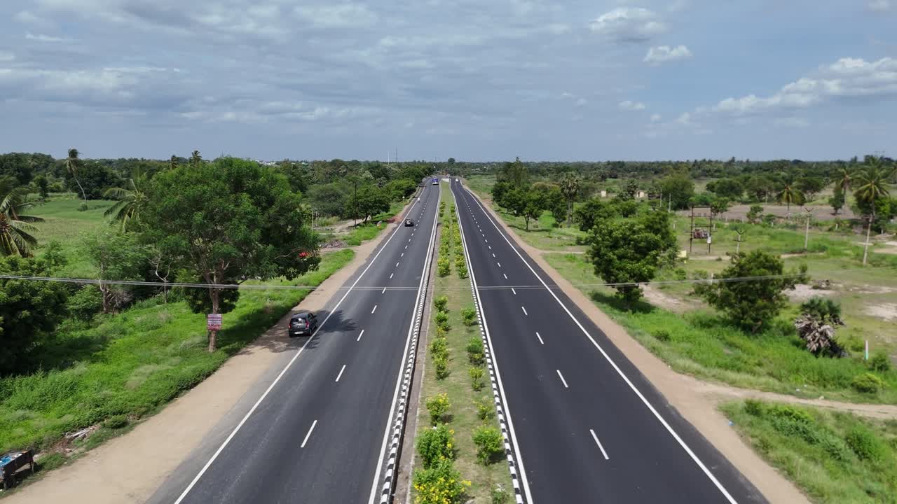 Aerial View of a Two-Lane Highway Through Lush Green Countryside