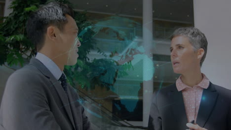 discussing with digital globe animation overlay, two business professionals in office setting