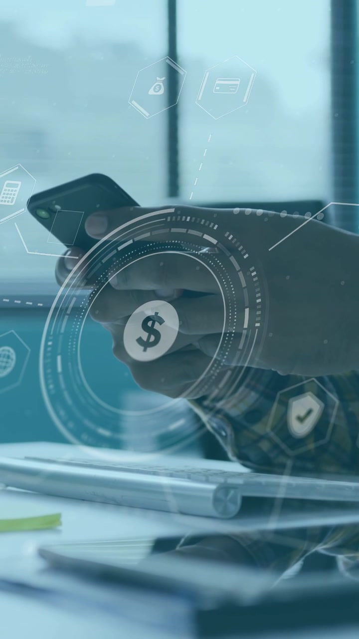 Vertical video: Man tapping phone at desk and activating pulsing finance HUD while reaching tablet