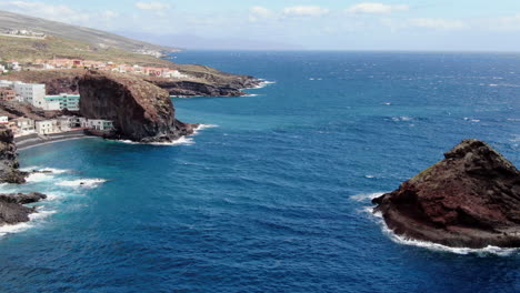 Roques-de-Fasnia,-Tenerife:-aerial-view-traveling-in-between-the-two-rock-formations-of-Fasnia-on-the-coast-of-Santa-Cruz-de-Tenerife