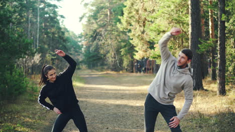 couple exercising outdoors in a forest