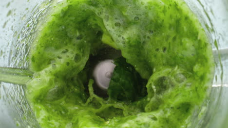 preparing vegetable green juice in super slow motion close up. detox smoothie.