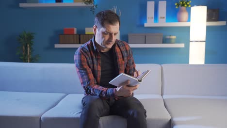 sad and lonely man crying at home, suffering from being alone, missing his family.