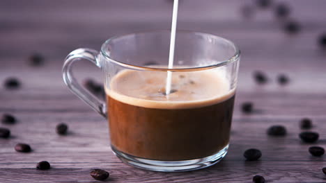 a jet of milk pouring into a cup of coffee