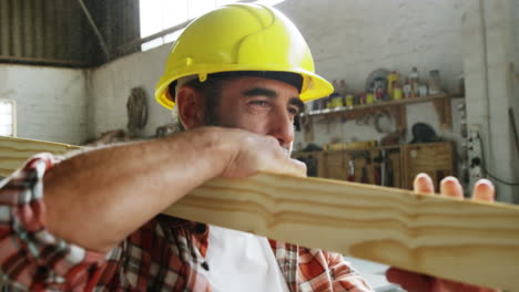 a carpenter carrying a wood piece