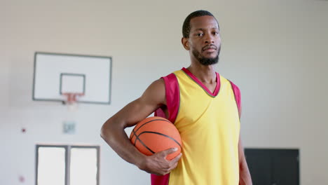 african american man poses confidently in a gym