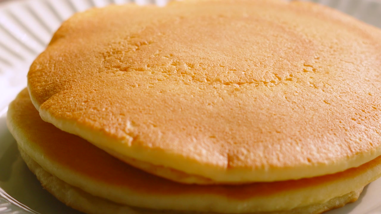 Slow Camera Move Across Soft Buttermilk Pancakes. Indulgent Breakfast Food.