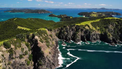 dramatic cliffs splashing by ocean aerial