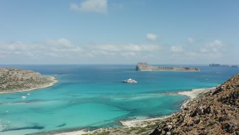 aerial drone shot revealing the ocean, cruise ship and islands