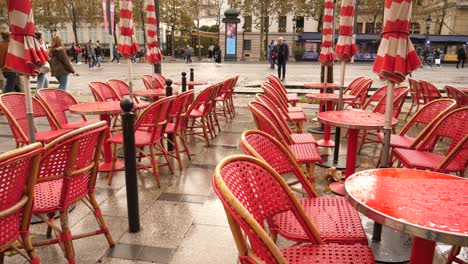 wet red tables poured by raindrops empty closed outdoors restaurant court in paris city center champs elysees