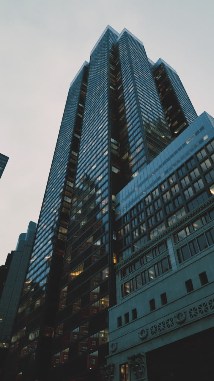 City skyscrapers tower above bustling streets during twilight