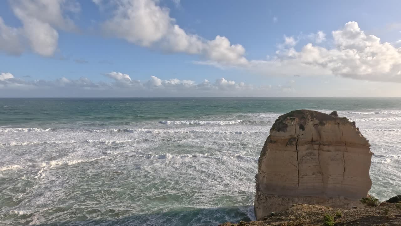 Ocean waves crashing against limestone formations