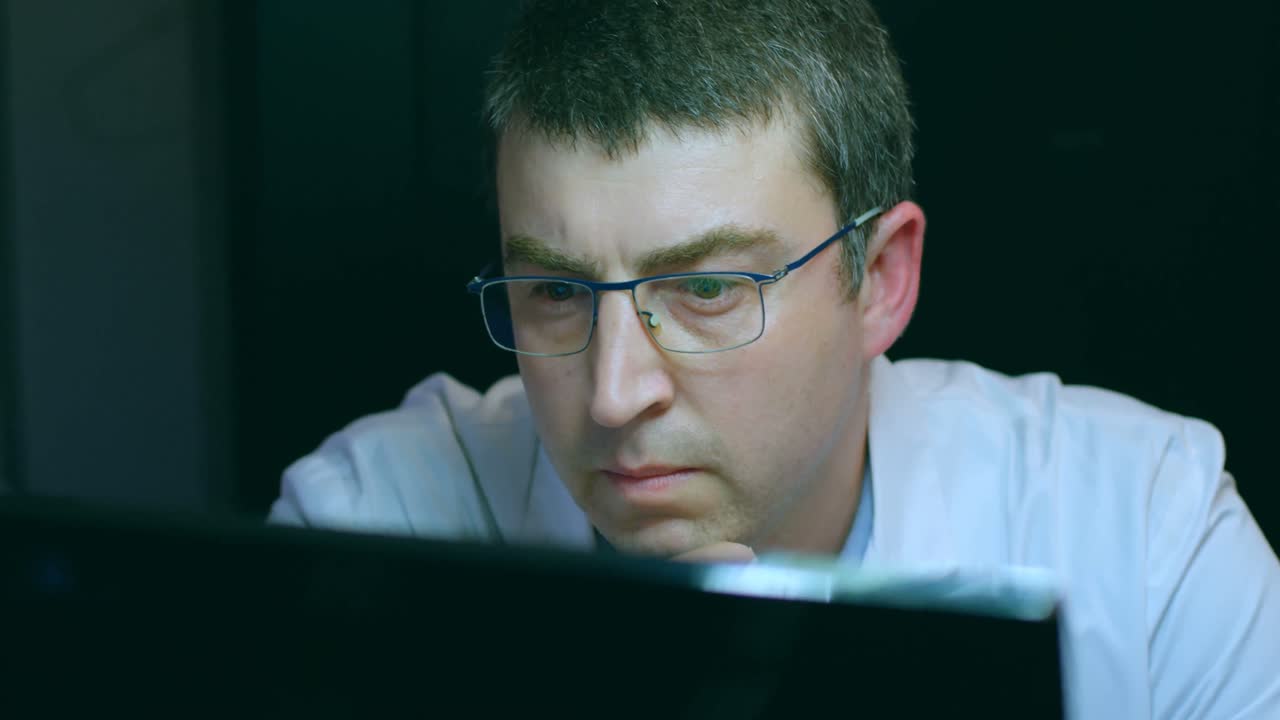 Male robotic engineer working at desk 4k