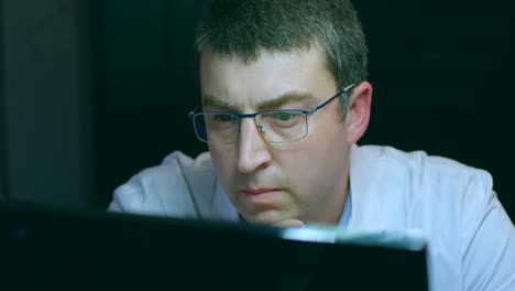 male robotic engineer working at desk 4k