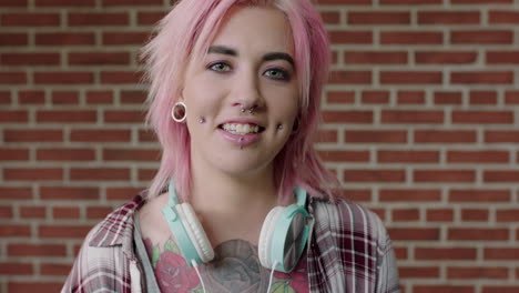 portrait of eccentric young woman pink hair looking alternative smiling happy