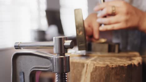 Caucasian-female-worker-shaping-jewellery-in-studio-in-slow-motion