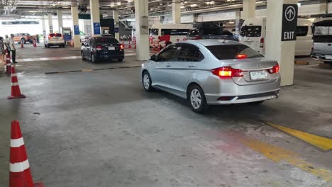 airport parking garage with cars and people