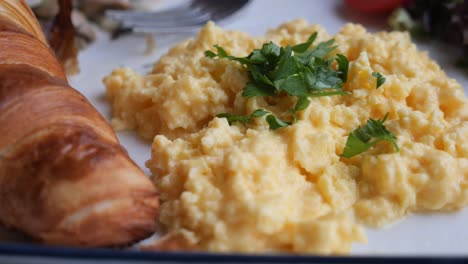 scrambled eggs with croissant breakfast