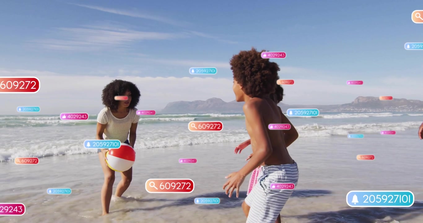 Family tossing beach ball at shoreline for recreation, activating AR numeric tags floating around