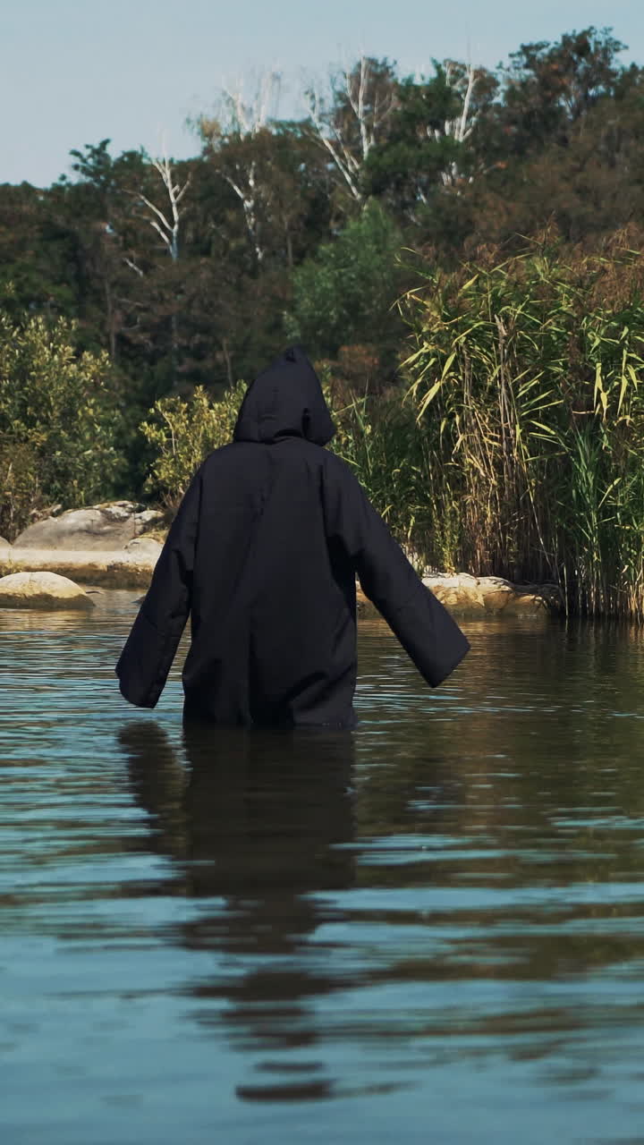 Ghost woman in the water outdoor. Divination by the water Vertical video