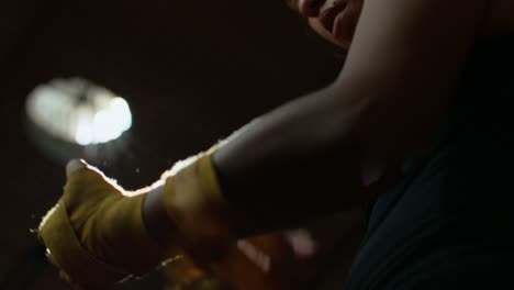 female athlete wrapping hands for boxing training