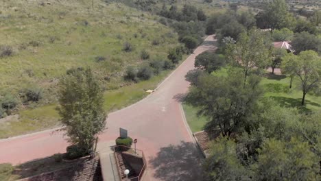 aerial-fly-over-a-lodge-with-green-trees-during-summer-time