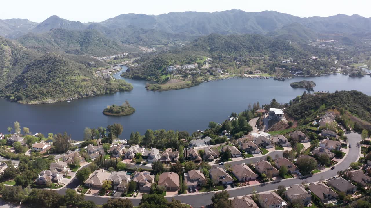 Aerial wide panning shot of the upscale lakefront community of Lake Sherwood, California. 4K at 30 FPS