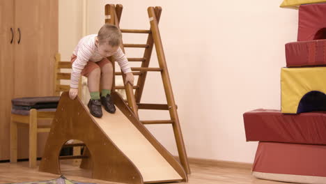 Young-boy-playing-on-an-indoor-playground