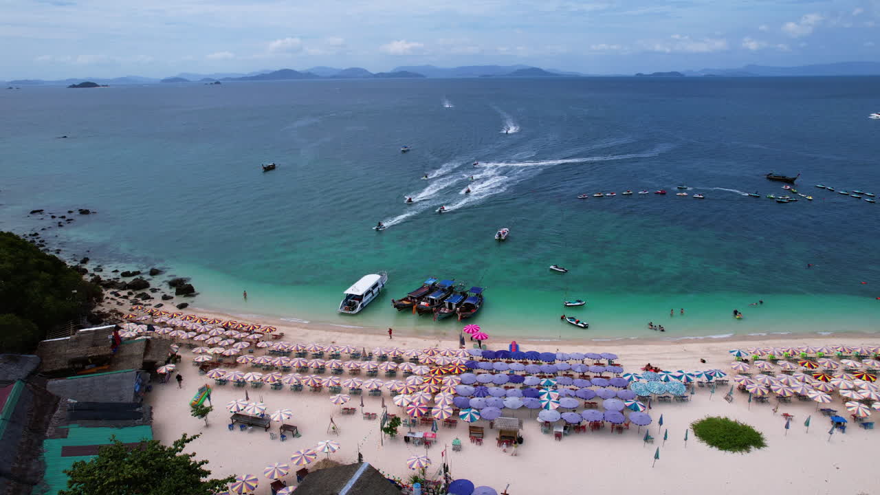 Static drone shot of multiple jet skis arriving at Koh Khai Nai island, Thailand
