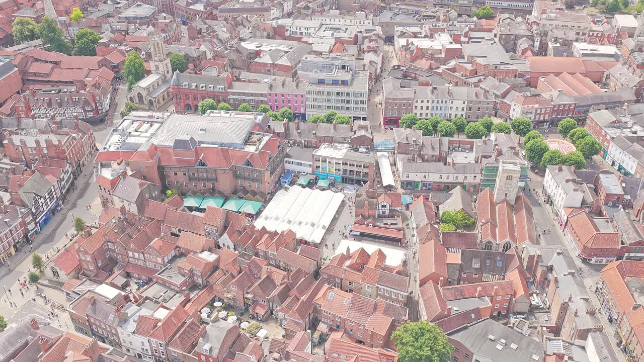 Top down aerial view of York historic shopping area, The Shambles, cobblestone lanes, medieval charm, red rooftops, summer tourism hotspot