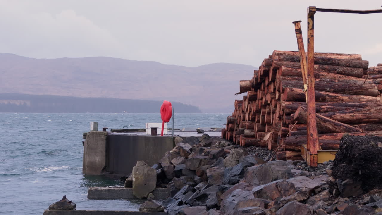 Wooden logs stacked on Lochaline West Pier, Scotland West Coast