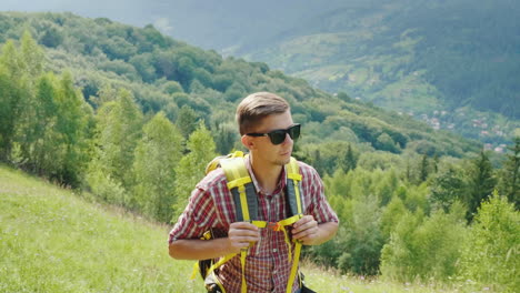 a very tired man tourist with a backpack goes up the mountain path willpower and physical endurance