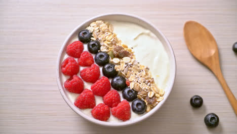 homemade yogurt bowl with raspberry, blueberry and granola - healthy food style