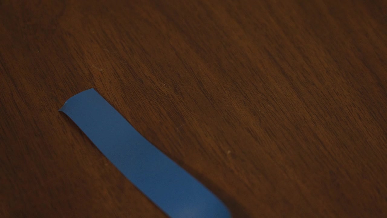 Blue electric tape laid out on wood