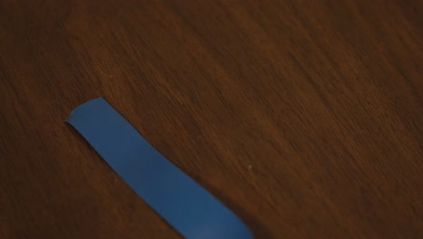 blue electric tape laid out on wood