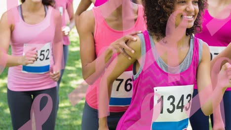 animation of multiple pink ribbon logo over diverse group of smiling women