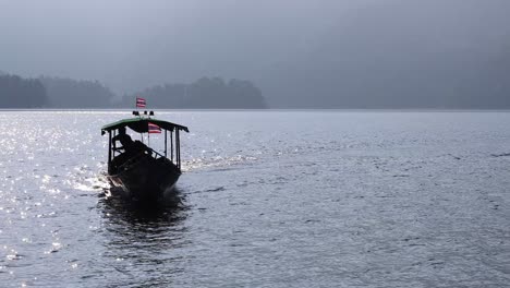 a boat moves steadily across a calm lake