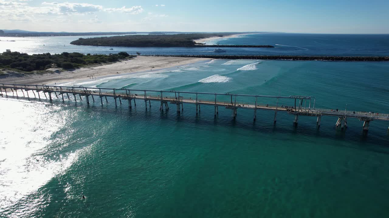 Idyllic Scenery Of Beach And Sand Pumping Jetty At The Spit In Queensland, Australia - aerial shot