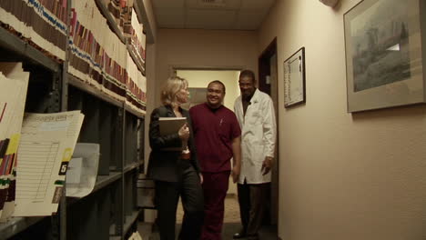 medical personnel walk through a hallway