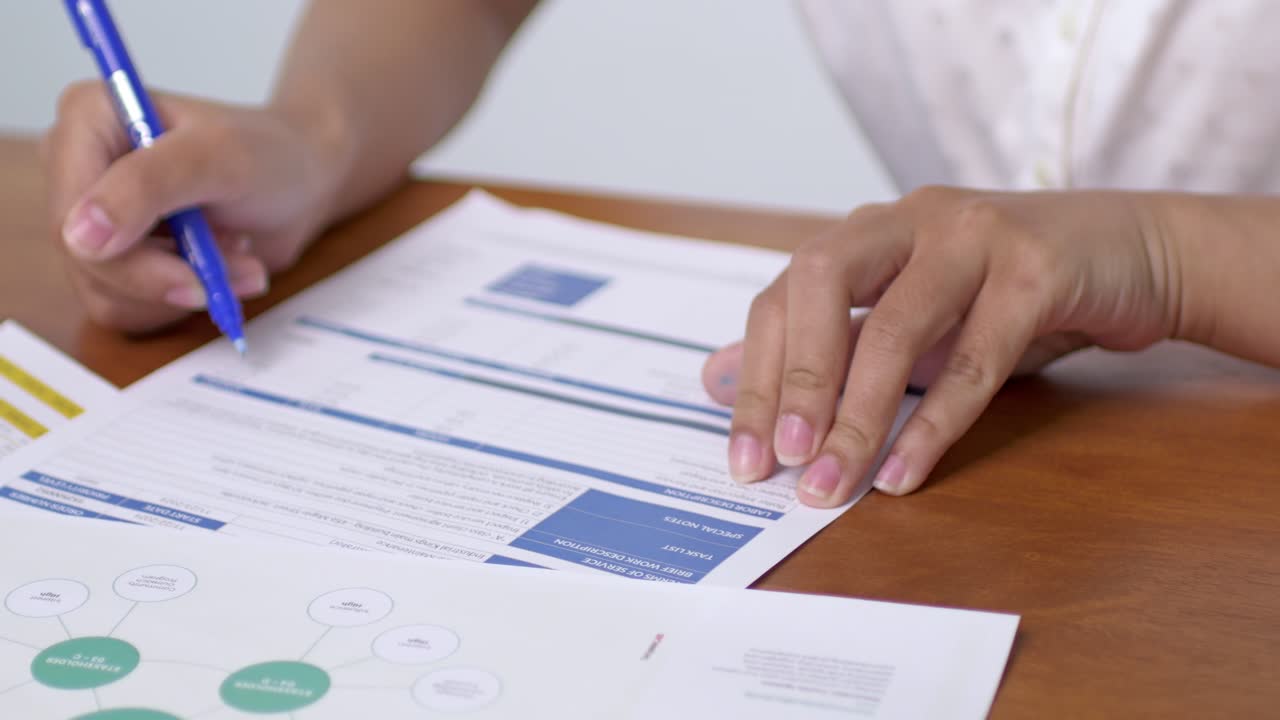 A focused individual reviews crucial business documents planning for future strategies an office environment